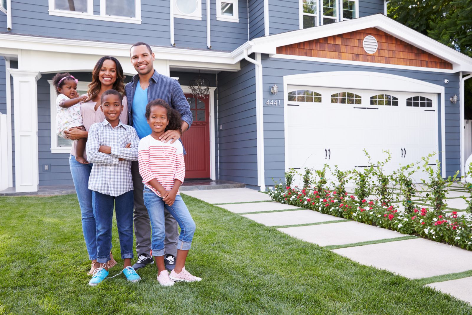 smiling couple in front of newhome